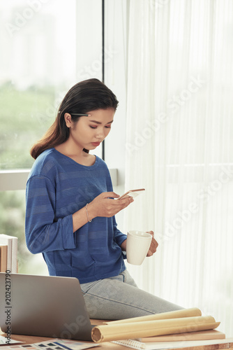 Creative woman with smartphone