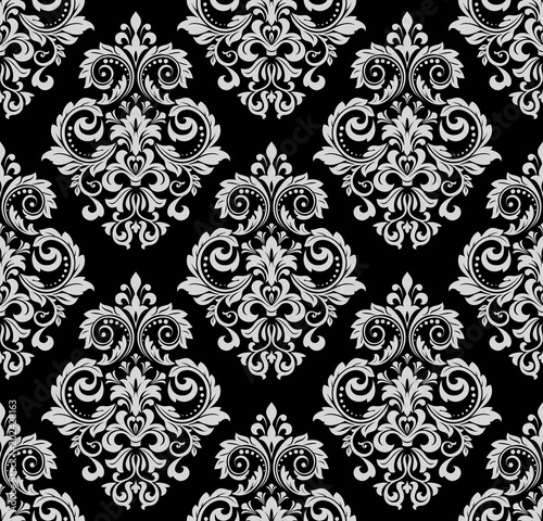 Wallpaper in the style of Baroque. A seamless vector background. White and black floral ornament. Graphic pattern for fabric, wallpaper, packaging. Ornate Damask flower ornament