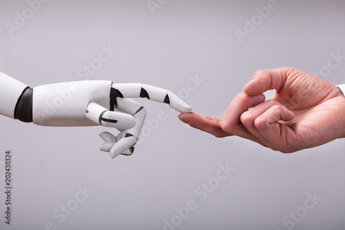 Robot Touching Human Finger photo