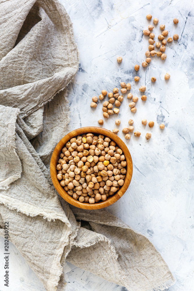 Dry chickpeas in a wooden bowl and linen cloth. Dry chickpeas in a wooden bowl and linen cloth.