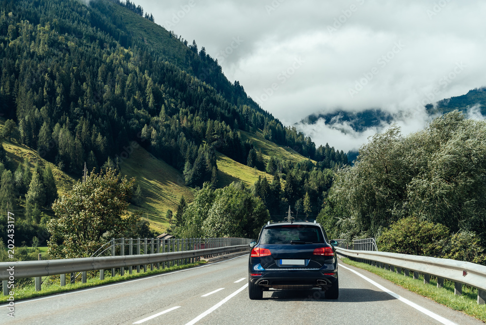 Scenic view of road crossing Alps mountains Scenic view of road crossing Alps mountains