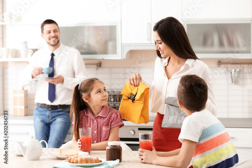 Young mother helping her ch...