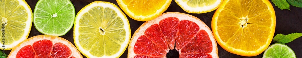 Banner of citrus food pattern on white background - assorted citrus fruits with mint leaves on black background Banner of citrus food pattern on white background - assorted citrus fruits with mint leaves on black background