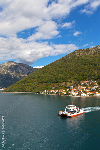 Montenegro. Beautiful view on Boka Kotor Bay and regular passenger ferry from Lepetane to Kamenari at sunny afternoon © Katvic