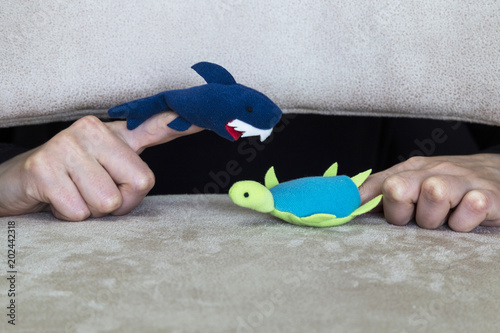 play with puppet and animals in the school. shark ,tortoise and hand on the ground for children activities. photo