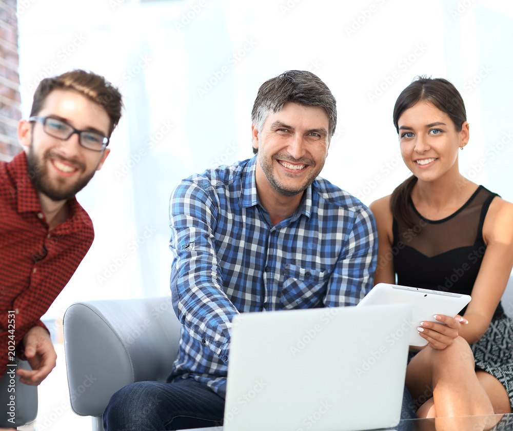 Group of young colleagues using laptop at office Group of young colleagues using laptop at office