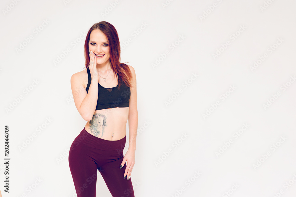 beautiful fitness girl brunette shows joy over white background beautiful fitness girl brunette shows joy over white background