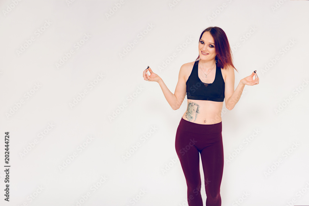 beautiful fitness and brunette girl showing joy and surprise on a white background beautiful fitness and brunette girl showing joy and surprise on a white background