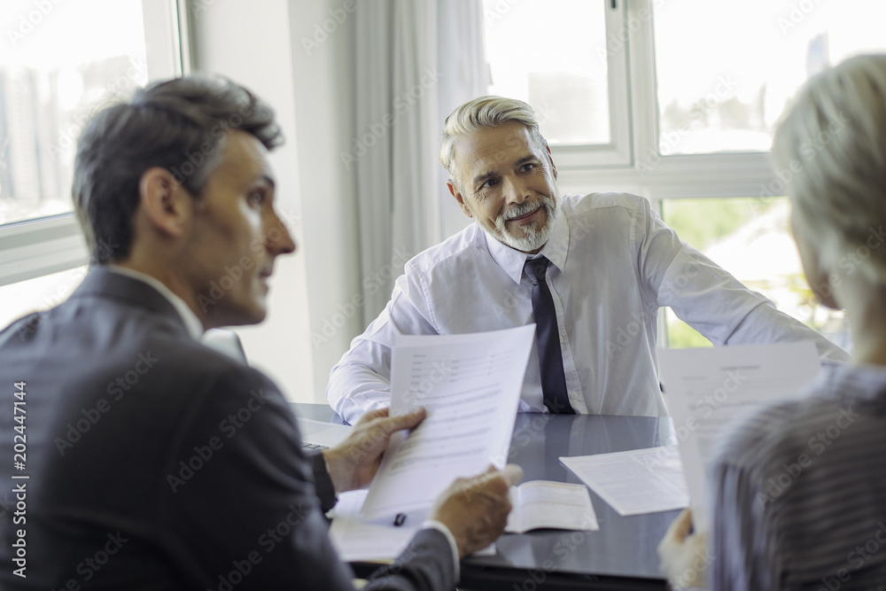 Businessman meeting with couple Businessman meeting with couple
