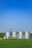 four silver silos at the field