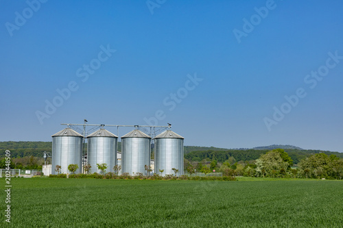 four silver silos at the field © travelview