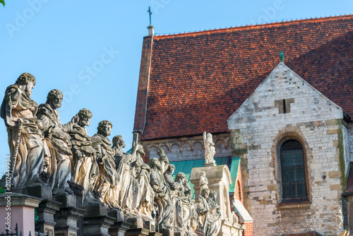 beautiful sculpture of 12 apostles against the background of the Catholic Church in Krakow photo