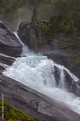 Stunning waterfall on the mountain river in Husedalen valley in Hardangervidda national park  Norway