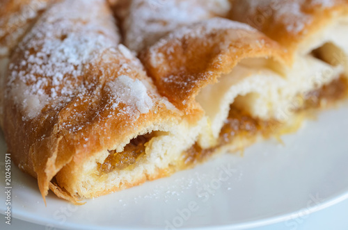 Piece of Ensaimada with Cabell d' angel, is coil-shaped flaky pastry from Mallorca, Balearic Islands. This is one of popular pastries in Spain eating at breakfast, snack time and dessert