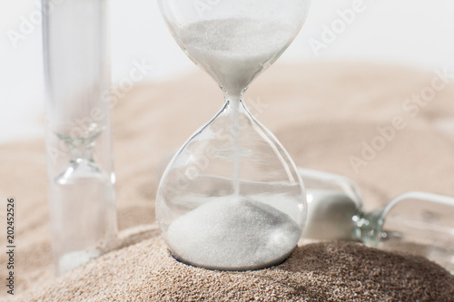 Time as sand. Hourglass in the desert