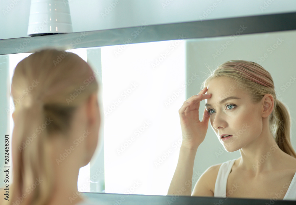 Face of young beautiful healthy woman and reflection in the mirror Face of young beautiful healthy woman and reflection in the mirror