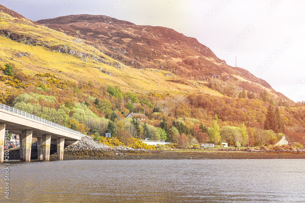 The village of Dornie, Other side of the road of Eilean Donan Castle, Dornie, Kyle of Lochalsh, Scotland At Sunrise The village of Dornie, Other side of the road of Eilean Donan Castle, Dornie, Kyle of Lochalsh, Scotland At Sunrise