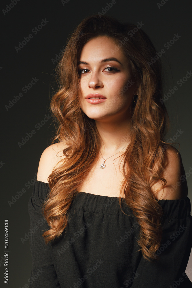 Stylish beauty portrait of a fashionable girl with makeup and hair