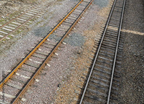 Railroad tracks on railway embankment of rubble. Three railroad tracks. Railway background