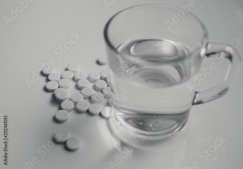 medicines and a glass of water
