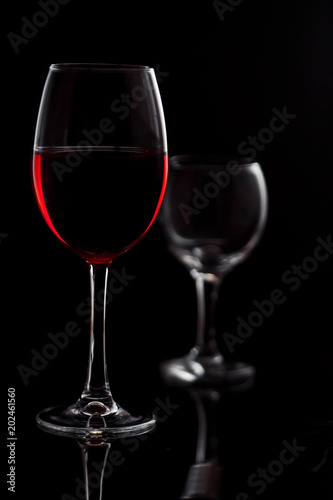 Glass with red wine on a black background