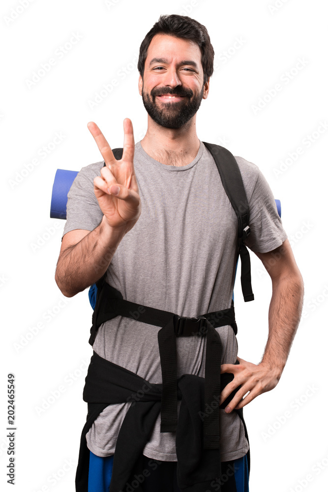 Handsome backpacker counting two on white background Handsome backpacker counting two on white background