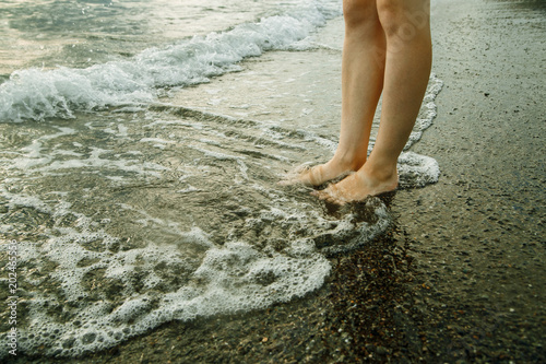 Feet in the water by the sea