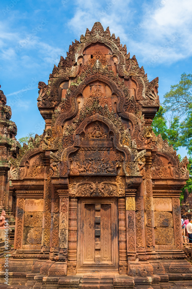 The facade of the north library in Cambodia's Banteay Srei (Citadel of the Women) temple. The pediment has a detailed bas-relief, depicting the scene of Indra dousing the fire at the Khandava forest.