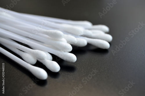 White Cotton Buds on Black Tile Surface photo