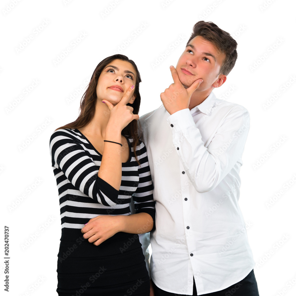 Young couple standing and thinking an idea on isolated white background Young couple standing and thinking an idea on isolated white background