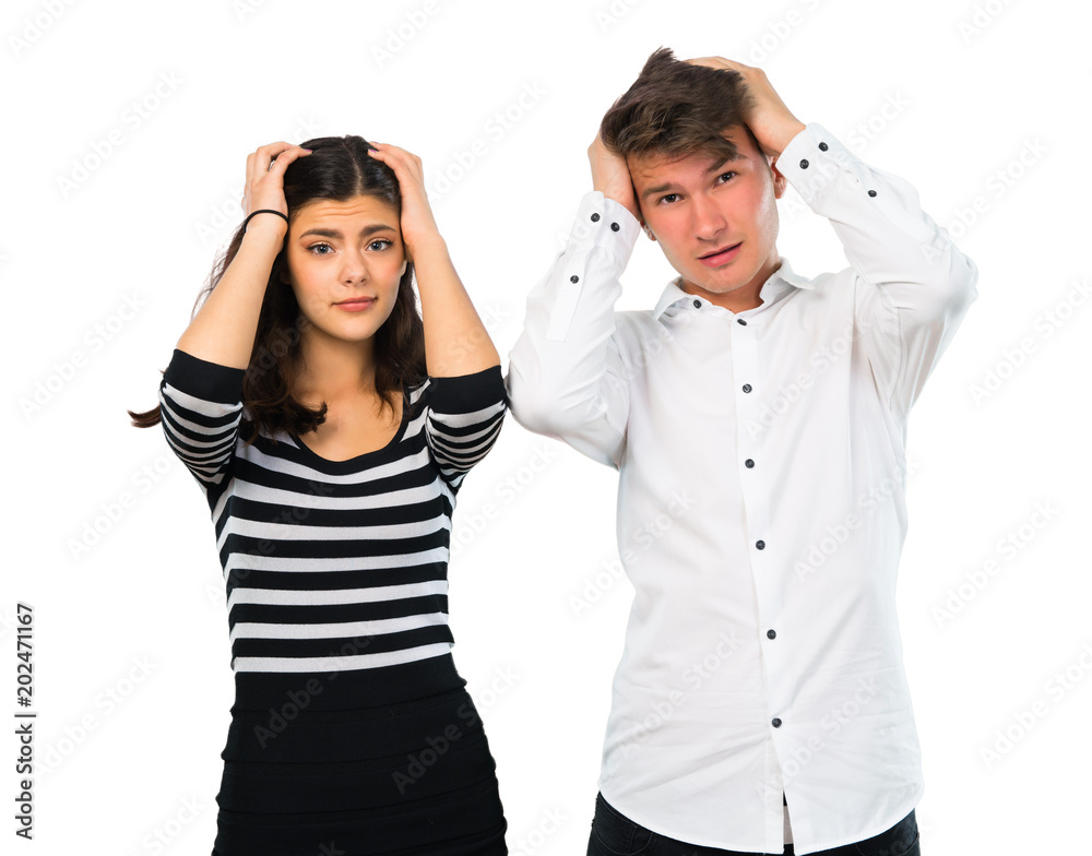 Young couple unhappy and frustrated with something. Negative facial expression on isolated white background