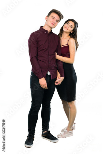Young teenager couple hugging on isolated white background