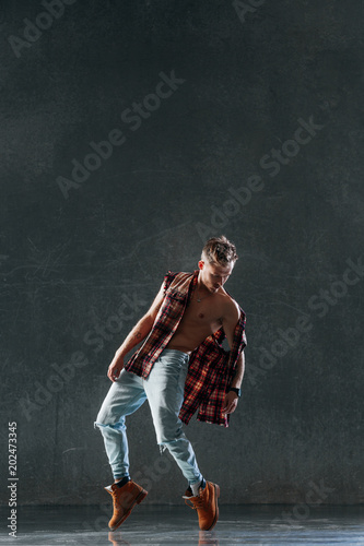Fototapeta Naklejka Na Ścianę i Meble -  Young beautiful male dancer posing in studio