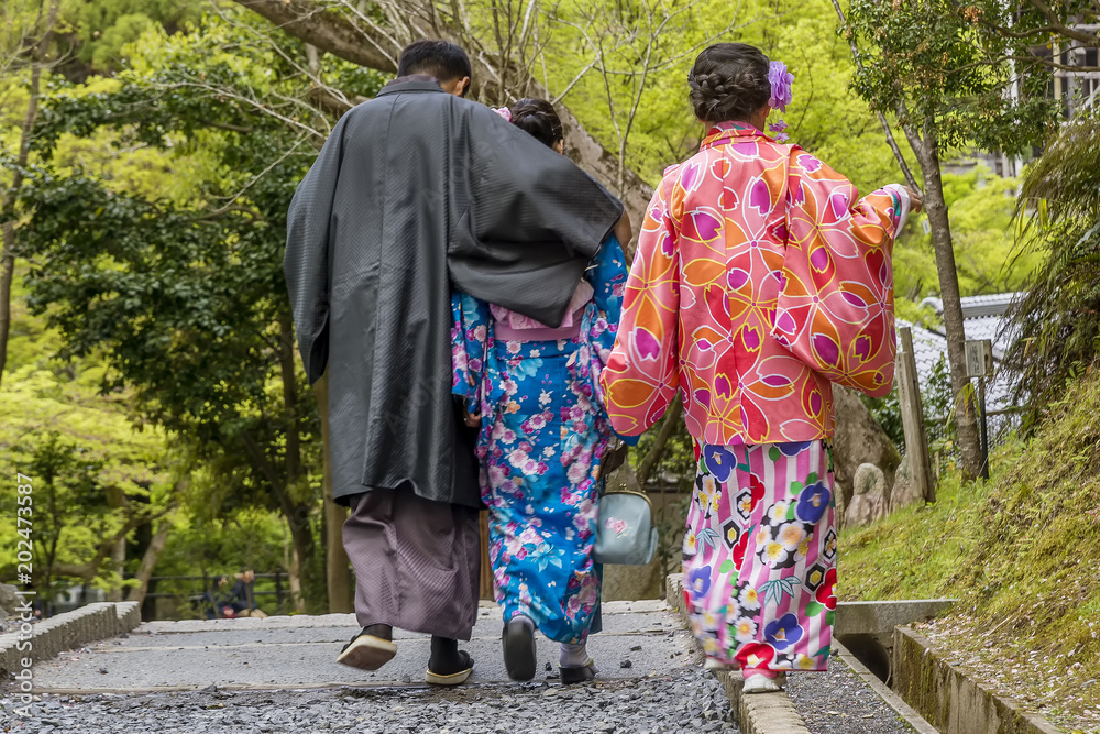 Japanese family in traditional clothes walking in Kyoto Kiyomizu dera Temple park, Japan