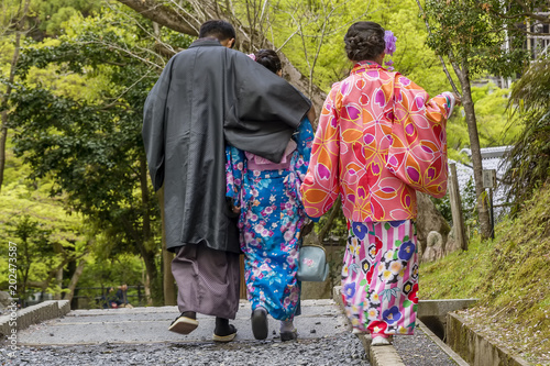 Japanese family in traditional clothes walking in Kyoto Kiyomizu dera Temple park, Japan