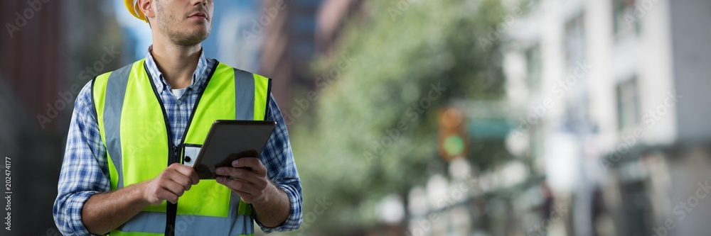 Composite image of concentrated construction worker with tablet - obrazy, fototapety, plakaty 