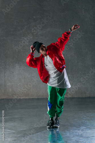 Young beautiful male dancer posing in studio