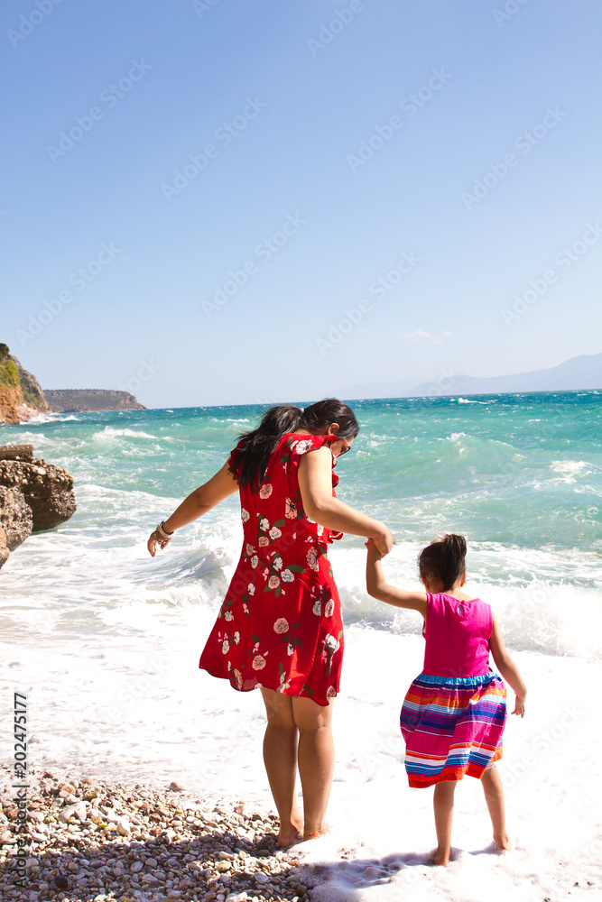 Mother and daughter by the seaside