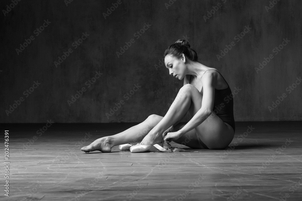 Fotografie Young beautiful ballerina is posing in studio
