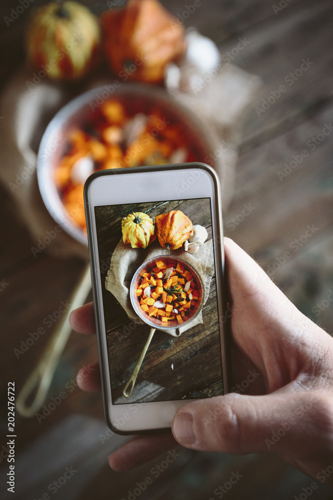 Taking photo of casserole of pumpkin dish with smartphone Taking photo of casserole of pumpkin dish with smartphone