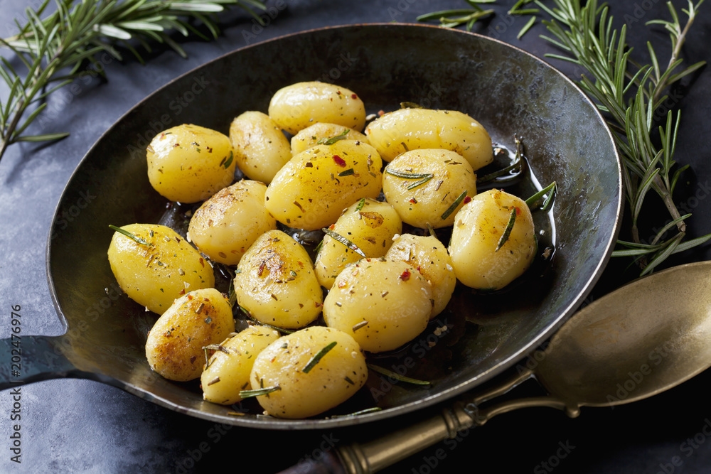 Fried potatoes with rosemary in pan Fried potatoes with rosemary in pan