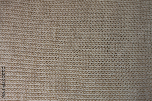 Horizontal wales on beige knitted fabric from above