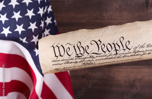 Preamble to the United States constitution with the American flag in background
