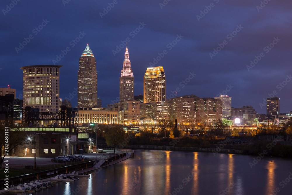 Cleveland, Ohio/USA - The Cuyahoga River and Cleveland Flats at night with downtown Cleveland and the Cleveland skyline visible in the background. 