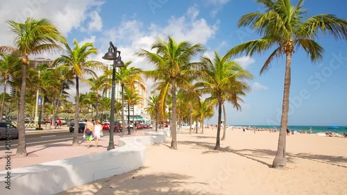 People having a rest on the Fort Lauderdale beach and walking on seafront. RAW video source.