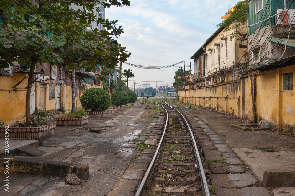 Vietnam. Railway crossing the street betwyn residential houses in Hanoi city Vietnam. Railway crossing the street betwyn residential houses in Hanoi city