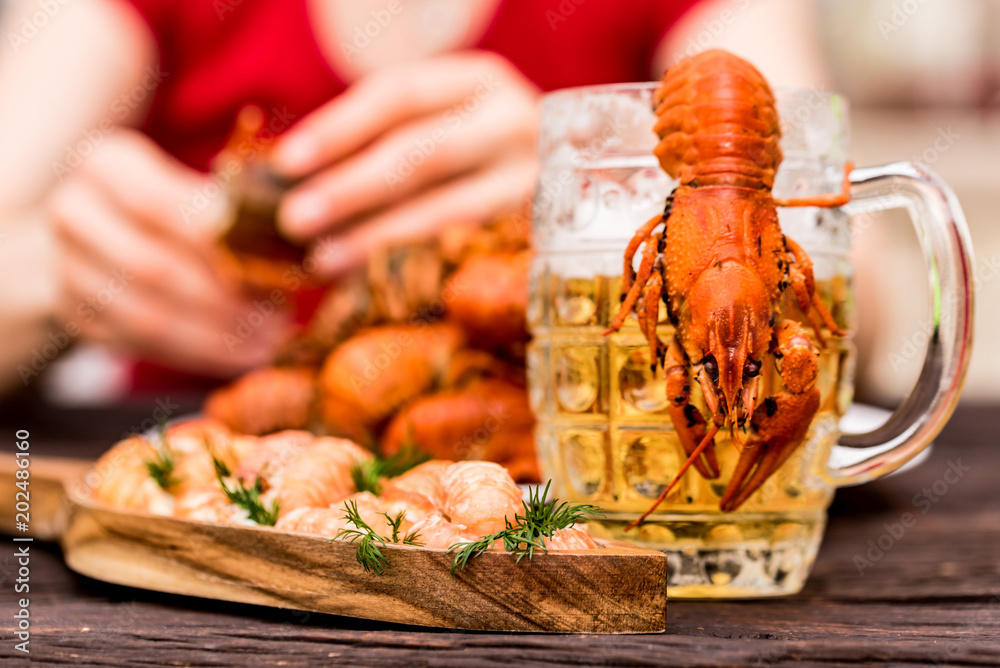 Boiled crayfish with beer on wooden background Boiled crayfish with beer on wooden background
