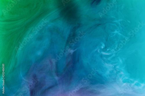 creative texture with blue and green flowing paint