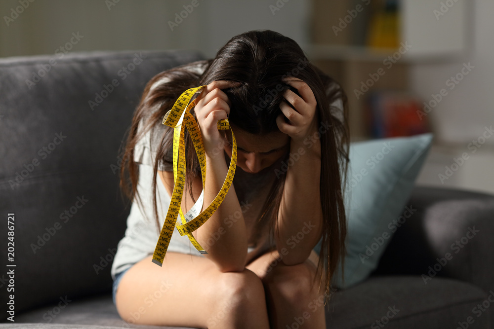 Ταπετσαρία Sad teen worried about appearance holding a measure tape