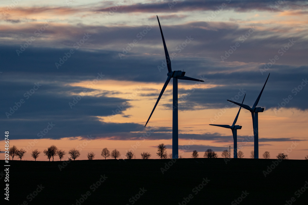 silhouette of three windmills at sunset silhouette of three windmills at sunset